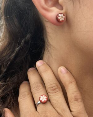 sesame seeds and mustard ring and stud earrings on red