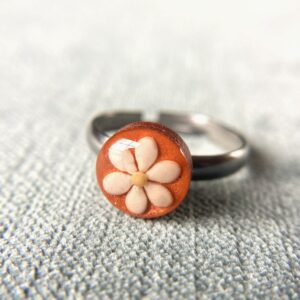 sesame seeds and mustard seed earrings on orange