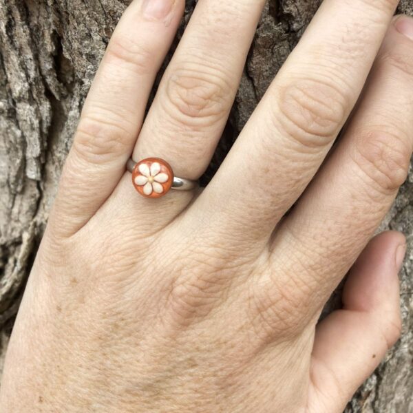 sesame seeds and mustard seed earrings on orange
