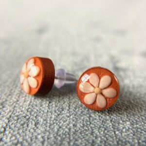 sesame seeds and mustard seed earrings on orange