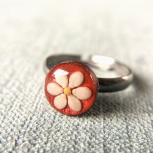 sesame seed and mustard seed ring on red
