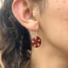 small red corn earrings on model